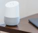 white and gray Google home on brown table